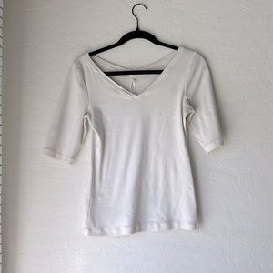 White tight fitting athropologie top. Size medium with elbow length sleeves.